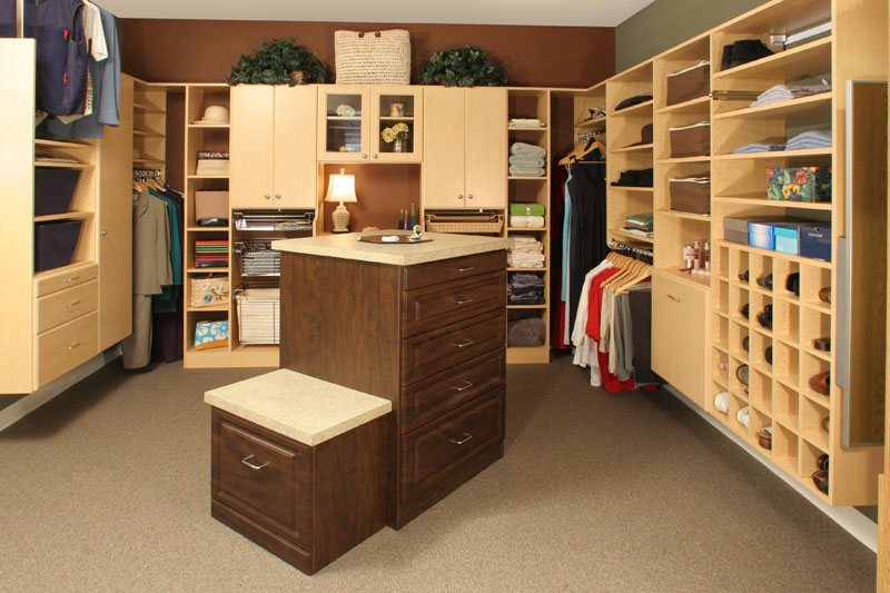 Closet drawers in closets can include islands with seats to increase space in the bedroom